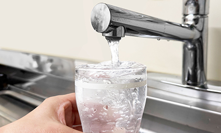 ニュースリリースメインイメージ。水道水をグラスに注ぐ